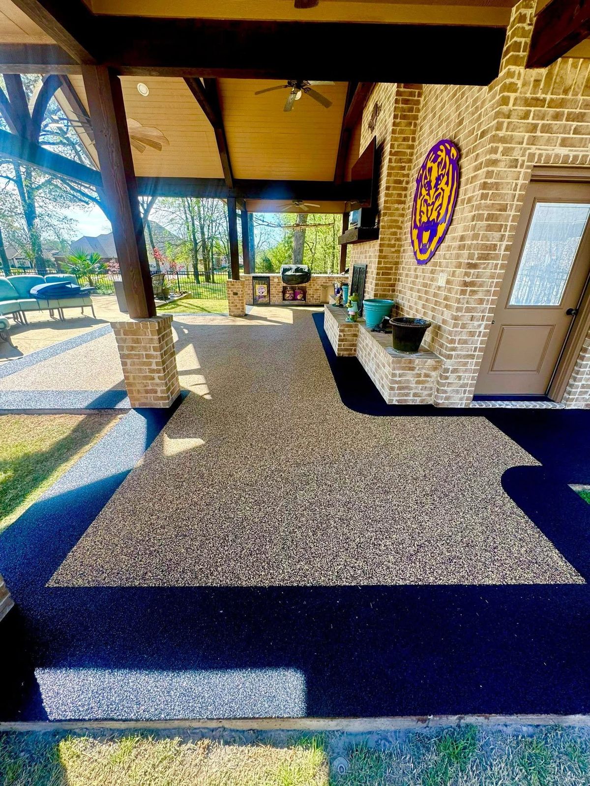 Decorative custom logo finish installed in a covered patio surface