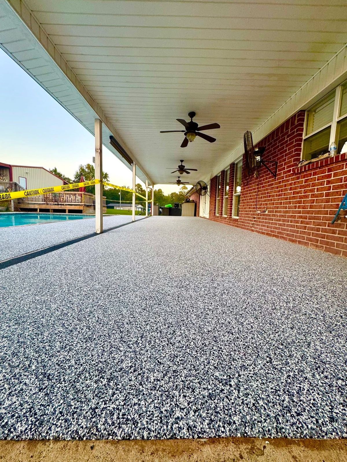 Long covered concrete walkway finished with Pro Coat rubber surfacing