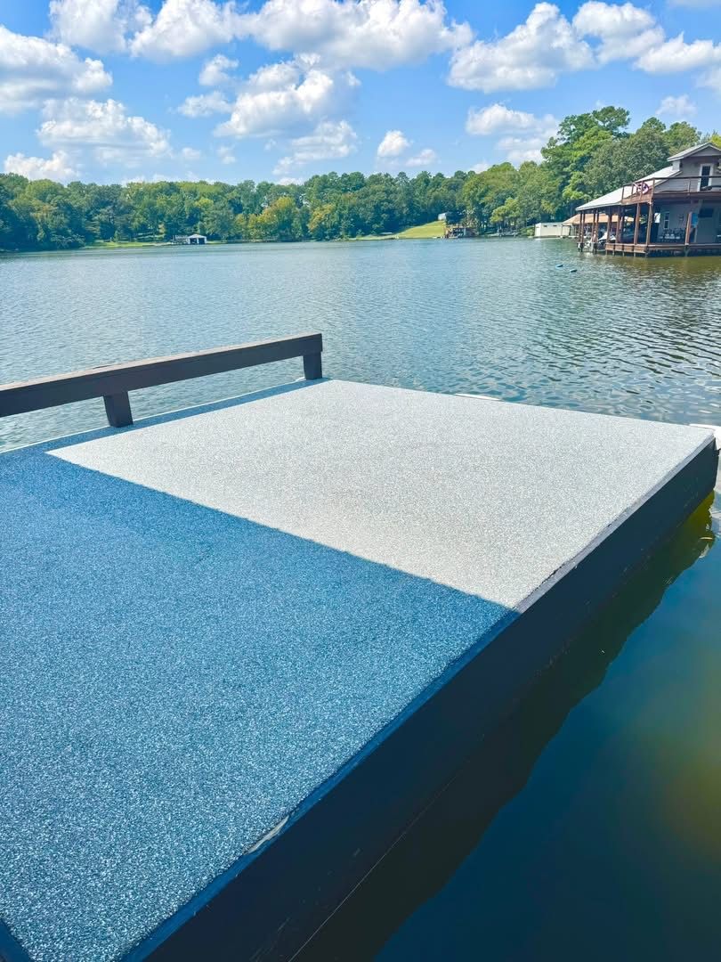 Boat dock finished in blue and white speckled coating on a lake